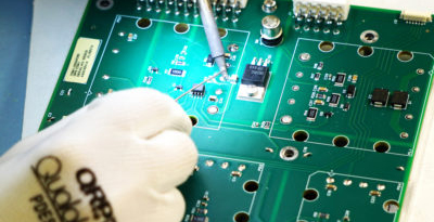 person soldering circuit board