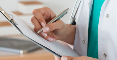 doctor checking clipboard