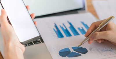 person checking graphs on paper