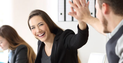 co-workers giving each other a high five